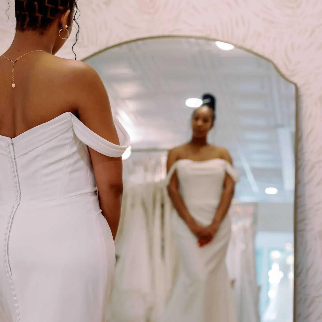 Model wearing a off the shoulder gown